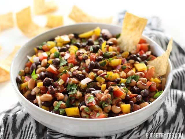 Front view of a bowl of Cowboy Caviar with tortilla chips.