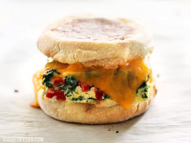 A reheated Veggie Packed Freezer Breakfast Sandwich close up, with melted cheese
