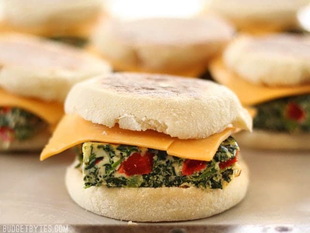 Veggie Packed Freezer Breakfast Sandwiches lined up and ready to be frozen, side view