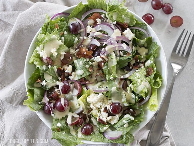 Top view of a plate of Grape Feta and Bacon Salad with a fork on the side