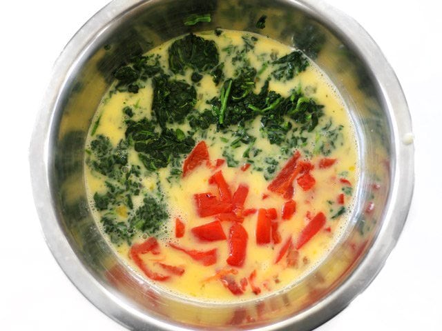 Spinach and Peppers added to whisked Eggs