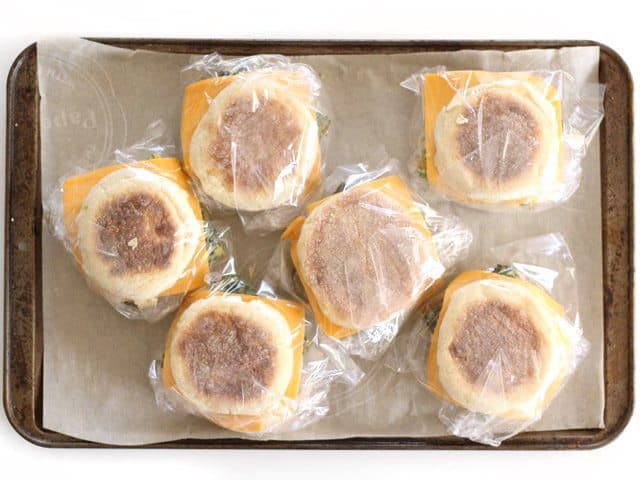 Freezer breakfast sandwiches wrapped in sandwich bags, ready to freeze