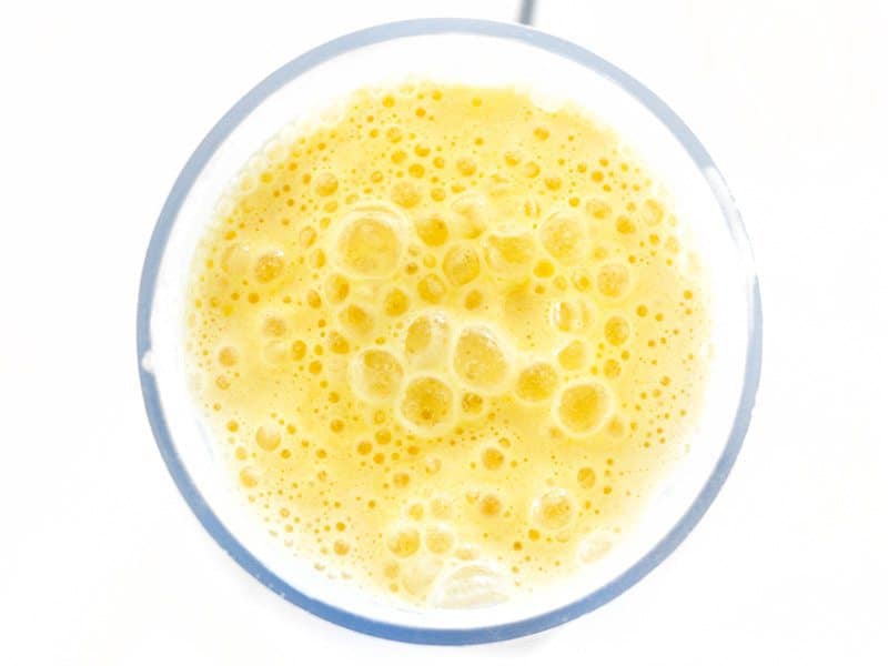 Blended Pineapple Orange Julius in the blender, viewed from overhead