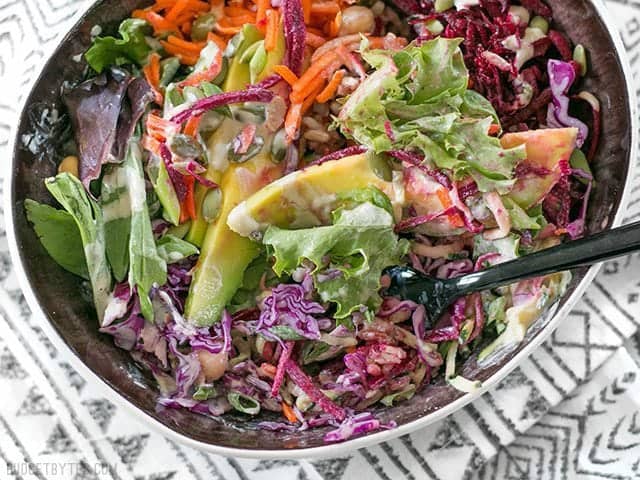 Side view of a Purple Power Bowl with dressing 