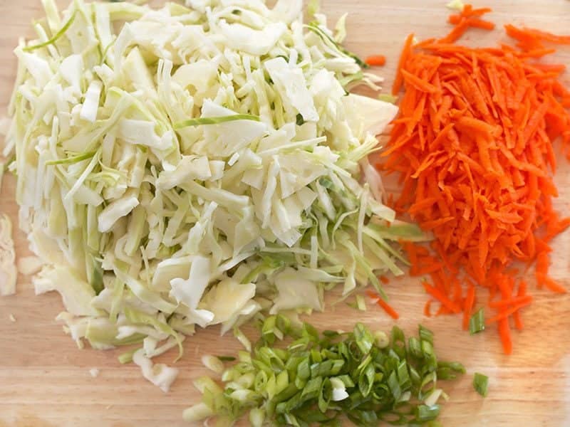 Shredded cabbage, carrot, and sliced green onion