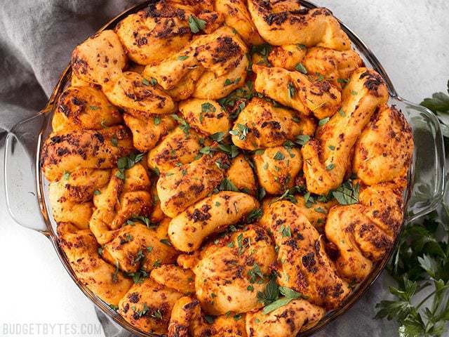 Baked Tomato Herb Pull Apart Bread garnished with chopped parsley