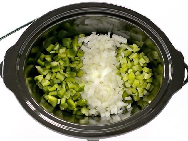 Celery, onion and bell pepper in bottom of Slow Cooker