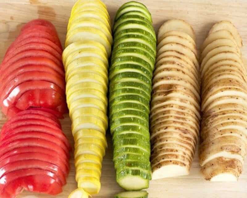 Sliced tomato, yellow squash, zucchini, and potato. 