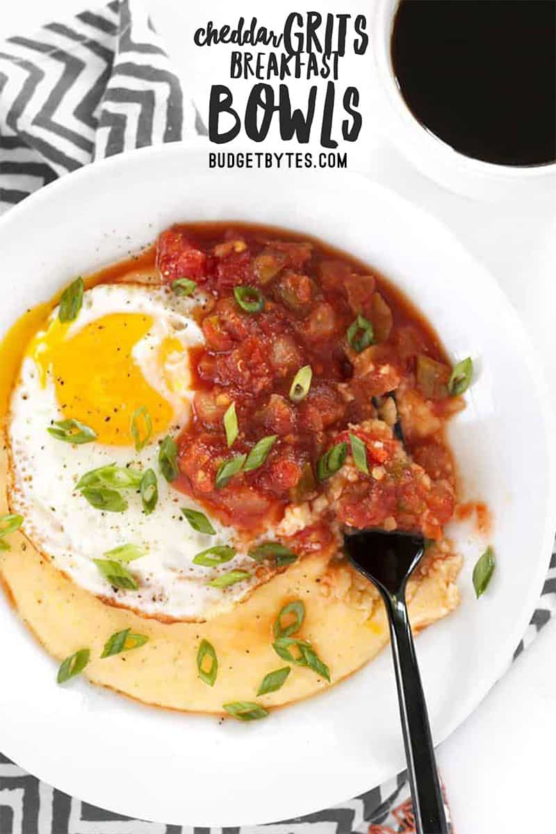 A fork digging into a Cheddar Grits Breakfast Bowl