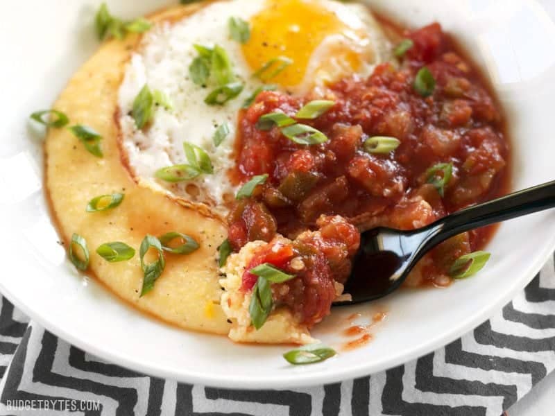 Cheddar Grits Breakfast Bowls are an easy but indulgent breakfast or brunch treat that you can whip up in no time. BudgetBytes.com Close up of a bite of Cheddar Grits Breakfast Bowl