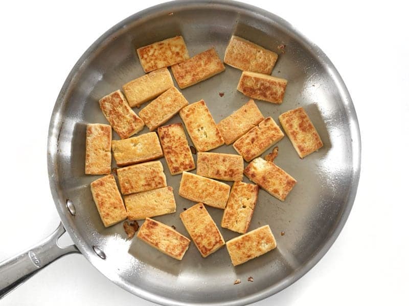 Fried Tofu pieces in a skillet, no sauce