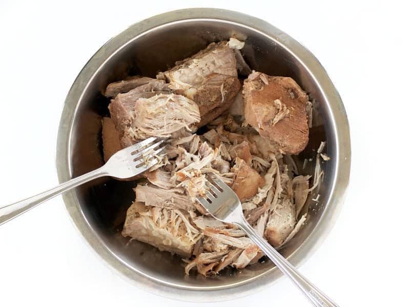 Remove Pork from Cooker and shred with two forks