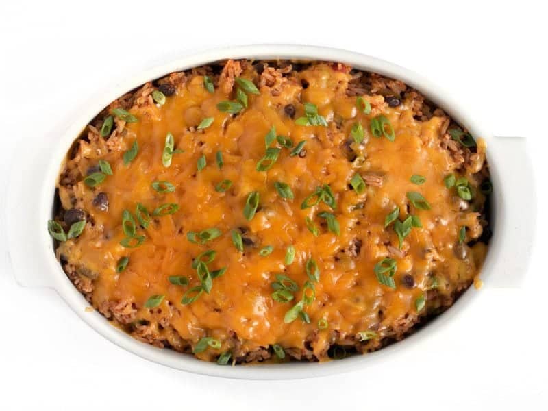 Beef Burrito Casserole baked with cheese on top, garnished with sliced green onions.