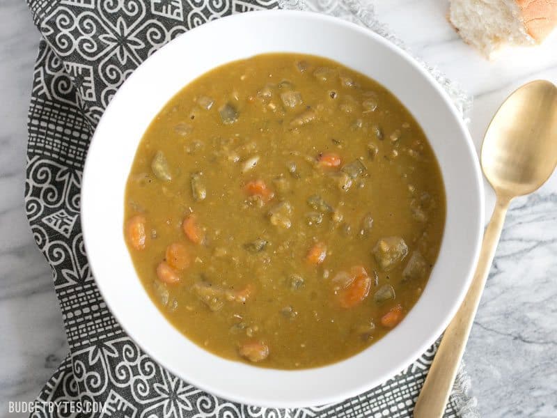 A bowl of Pressure Cooker Split Pea Soup seen from above, on a patterned napkin.