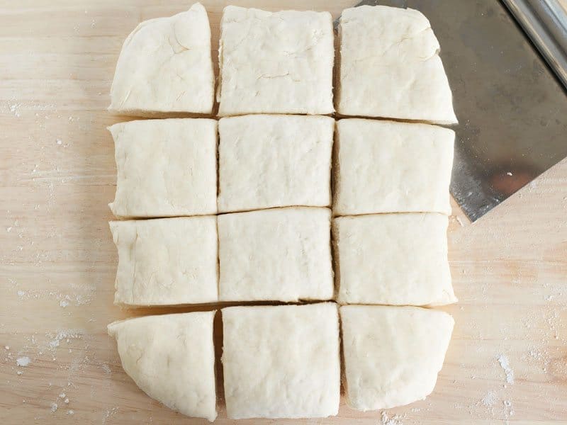 Biscuit dough shaped into a rectangle and cut into squares