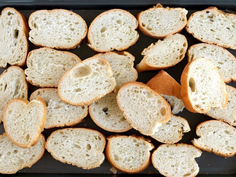 Dry Out Bread by toasting slices in the oven on a baking sheet