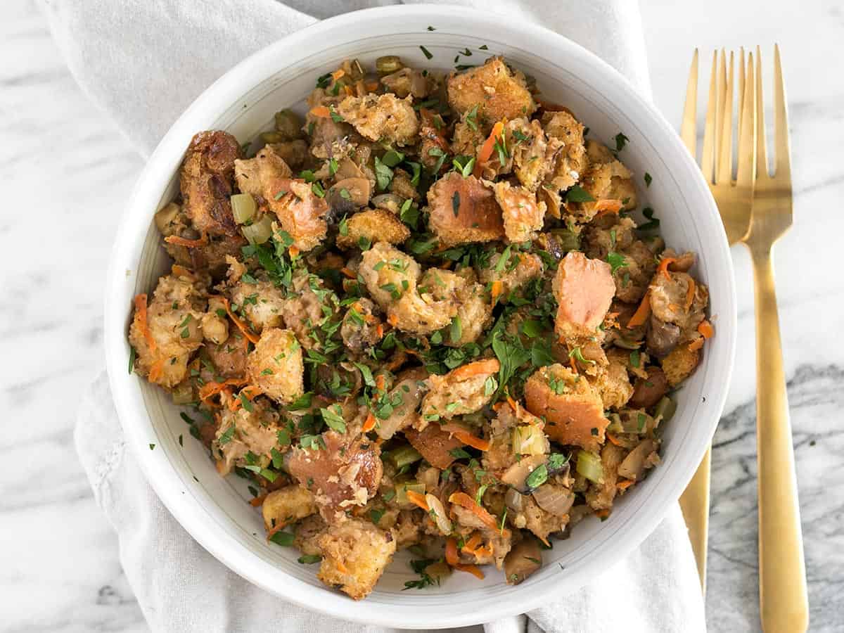 Overhead view of a bowl full of vegetarian stuffing with a fork on the side.