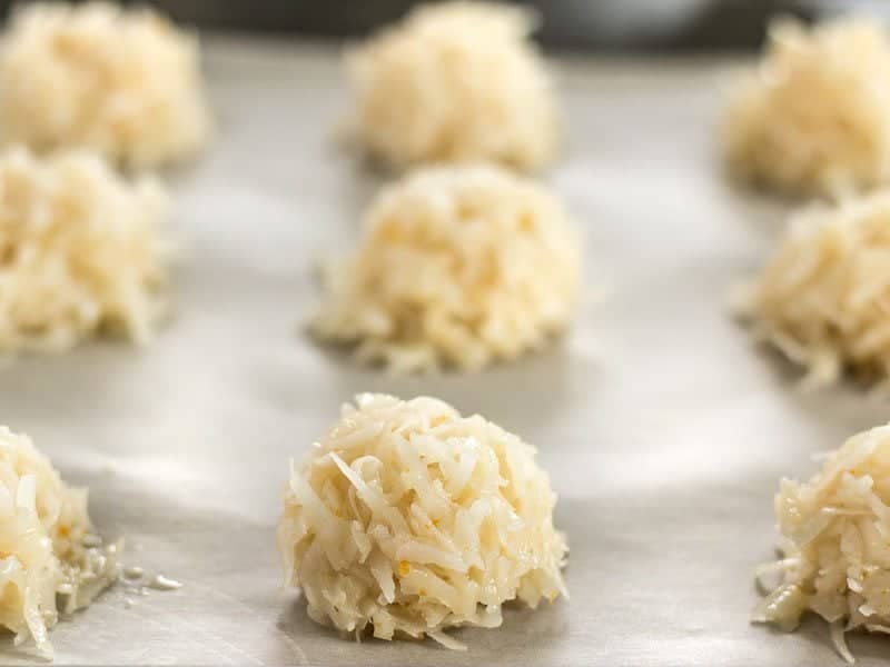 Macaroons Ready to Bake, on a parchment lined baking sheet, viewed from the side