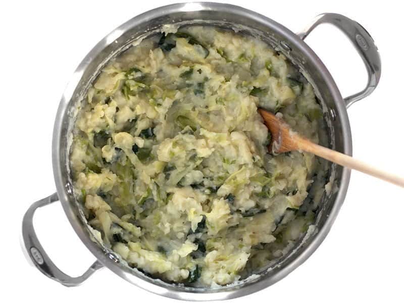 Mashed Colcannon in the stock pot with a wooden spoon