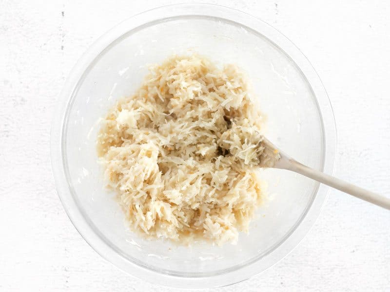 Mixed Macaroon Batter in the bowl with a wooden spoon