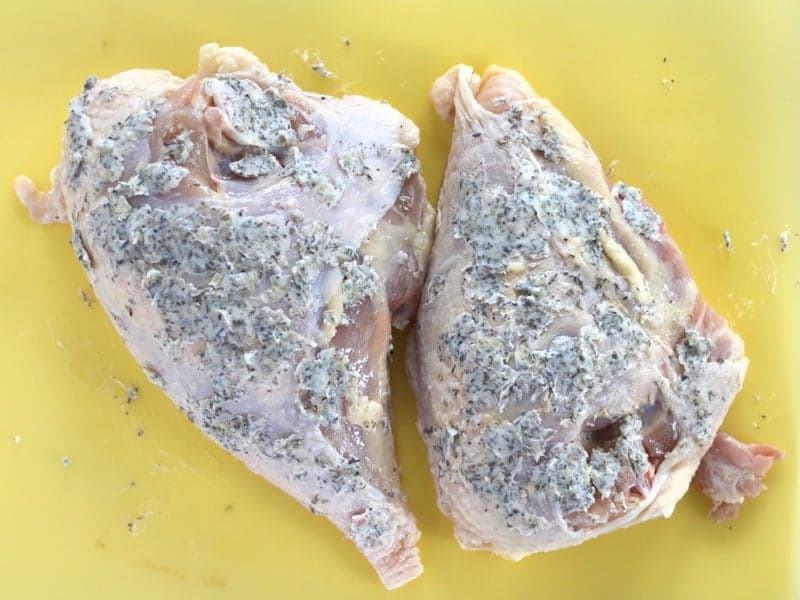 Garlic Herb Butter spread all over the skin of the Chicken