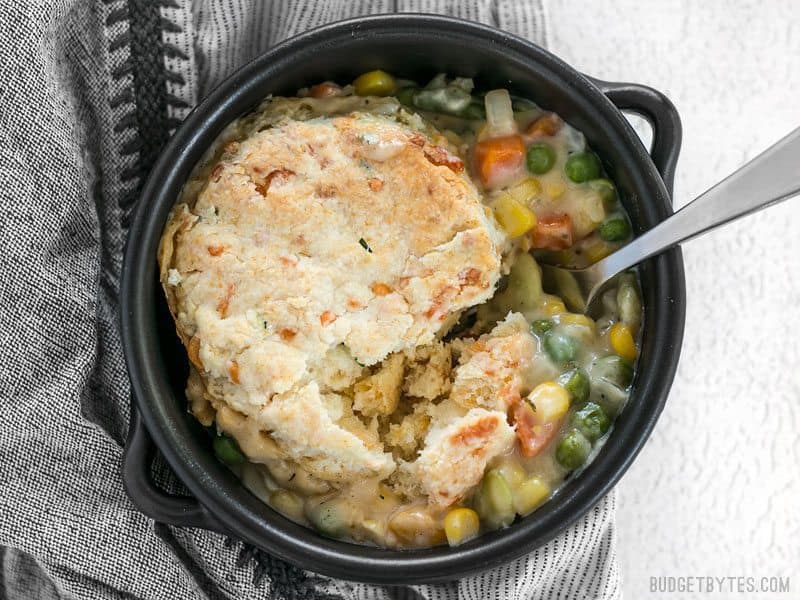 One bowl of warm and comforting Vegetable Pot Pie with a Cheddar Biscuit on top.
