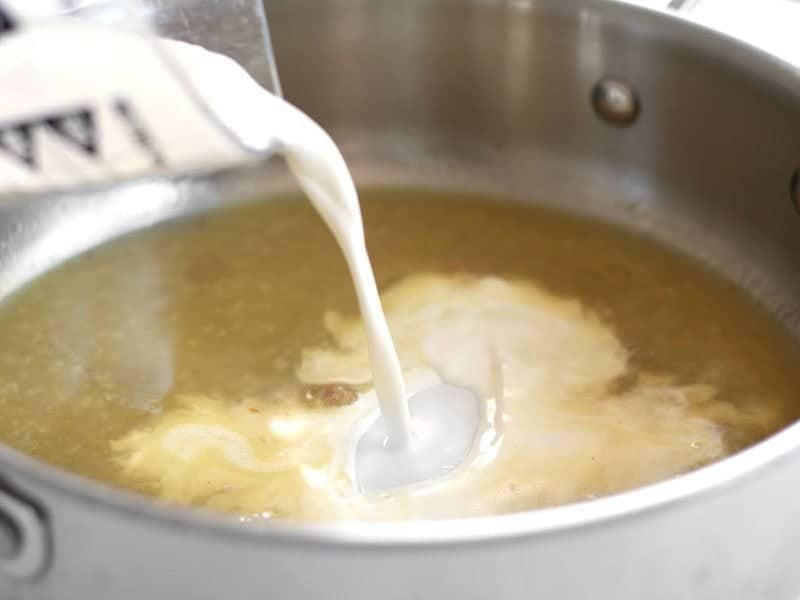 Add Heavy Cream to the chicken broth in the skillet