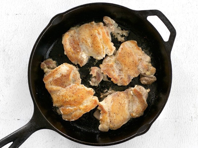 Browned Chicken Thighs in a cast iron skillet