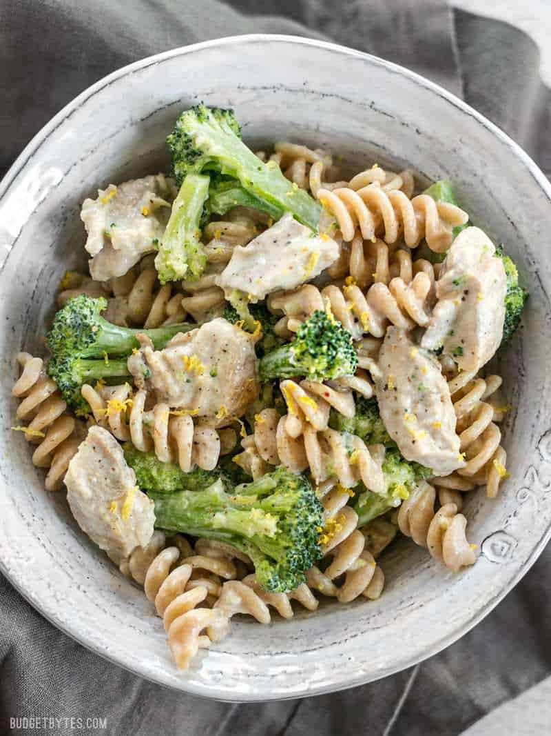 Close up overhead shot of Chicken and Broccoli Pasta with Lemon Cream Sauce garnished with lemon zest