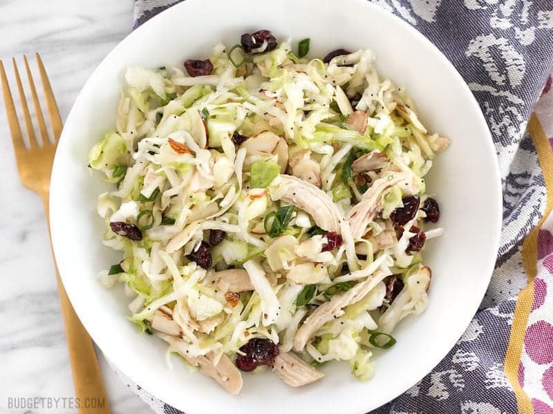 Overhead view of Chicken and Cranberry Salad with a purple napkin and gold fork
