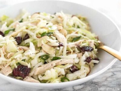 This Chicken and Cranberry Salad combines tender cabbage, nutty almonds, sweet cranberries and a tart lemon poppy seed dressing, plus enough chicken to make it a meal. BudgetBytes.com