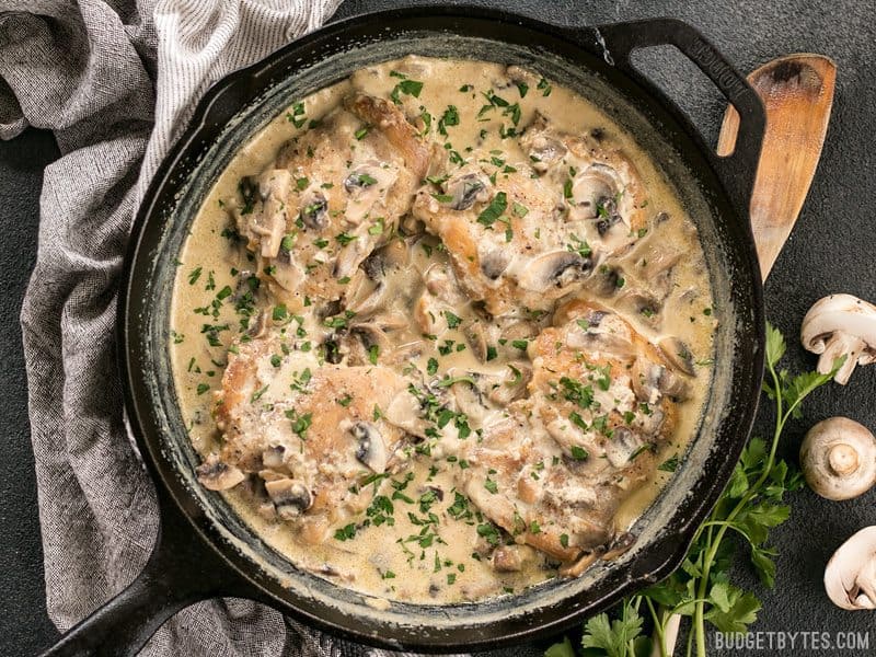Finished Creamy Garlic Mushroom Chicken in the skillet, garnished with chopped parsley