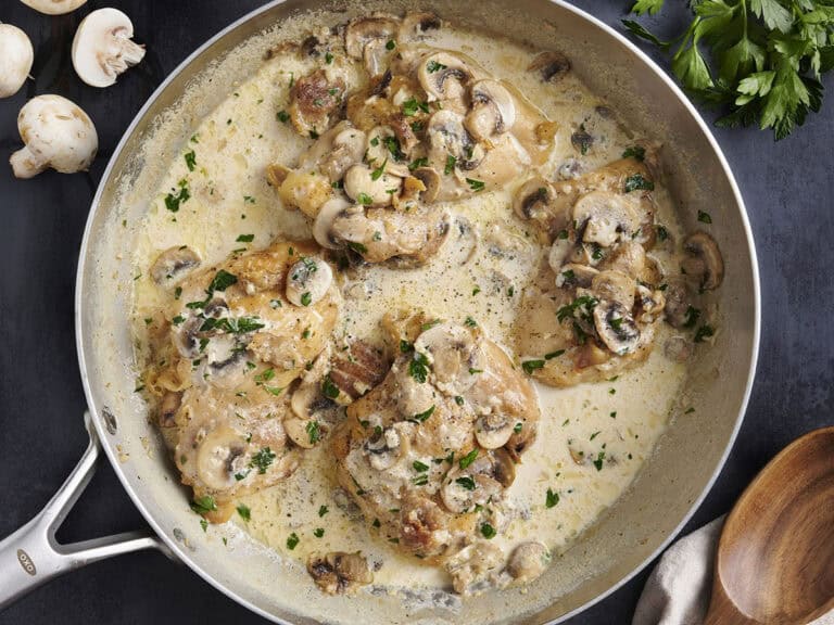 Overhead view of creamy mushroom chicken in a skillet.