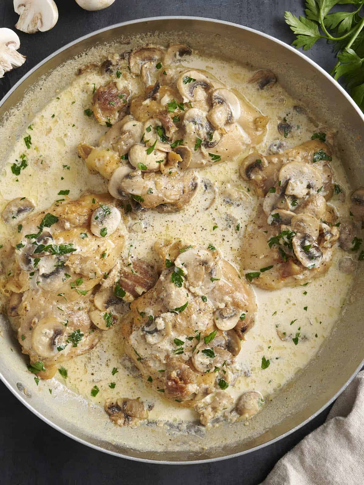 Simple pan sauces save the day in this quick and easy Creamy Garlic Mushroom Chicken! BudgetBytes.com Overhead view of creamy mushroom chicken in a skillet.