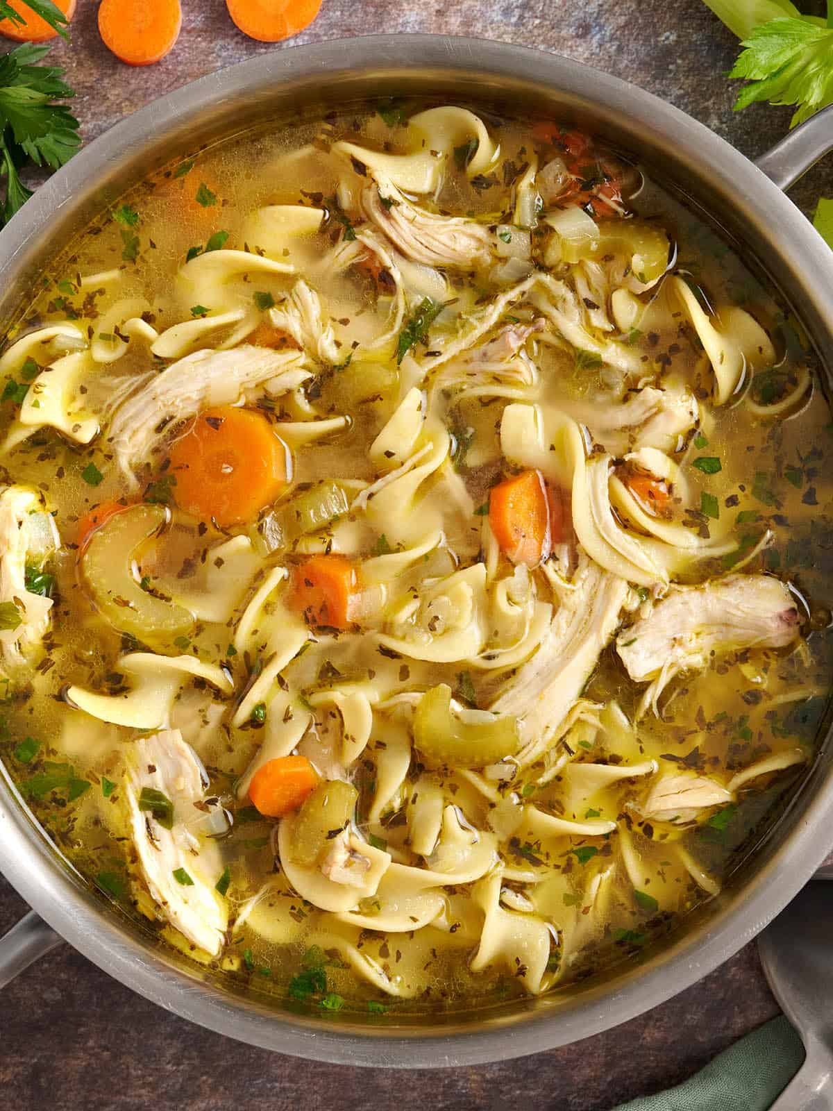 Overhead view of a pot of homemade chicken noodle soup.