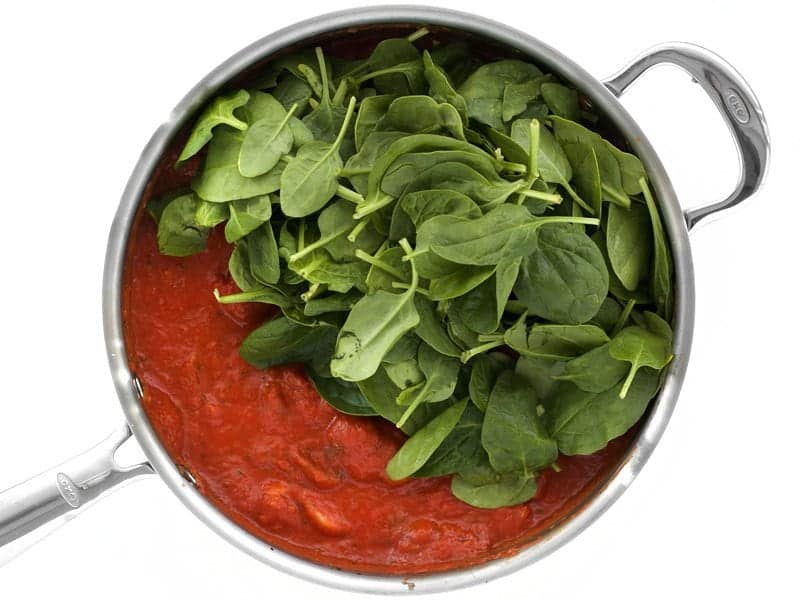 Add Fresh Spinach to red sauce in the skillet