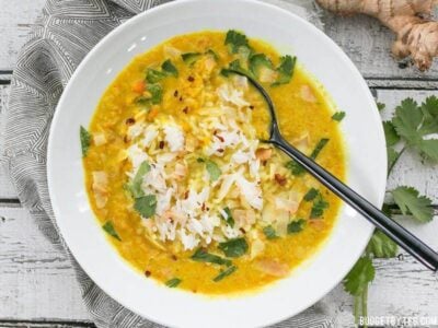 Golden Coconut Lentil Soup is a light and fresh bowl with vibrant turmeric and a handful of fun toppings. BudgetBytes.com