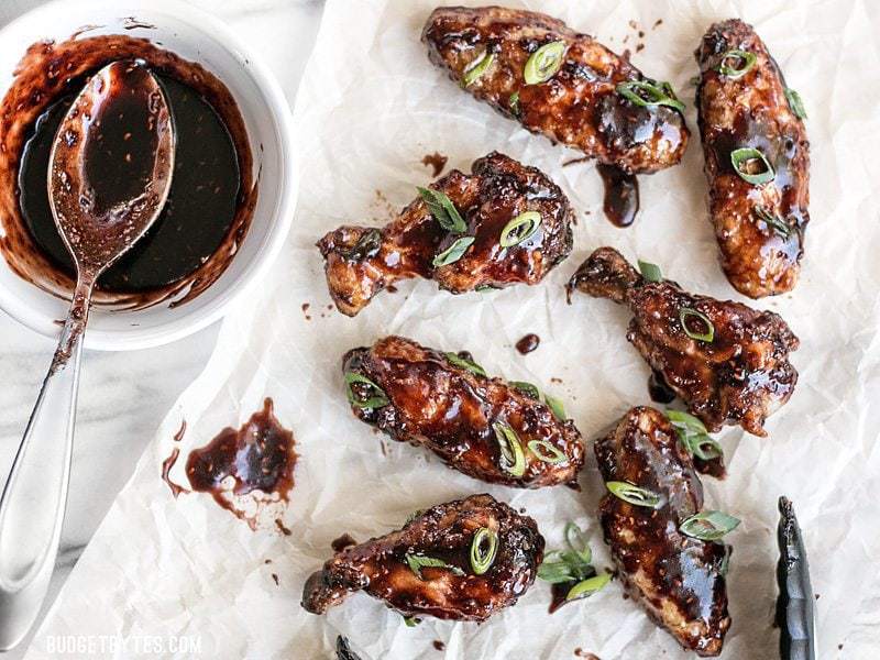 Raspberry Balsamic Baked Chicken Wings next to a dish of raspberry balsamic glaze