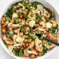 This Roasted Cauliflower Salad combines sweet roasted red onions, spiced chickpeas, tender cauliflower, and a tangy lemon tahini dressing. BudgetBytes.com