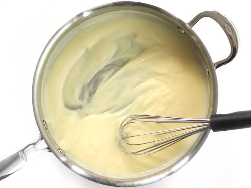 Thickened Broth and Roux in the skillet with a whisk