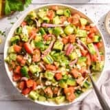Overhead view of a bowl of cucumber tomato salad.