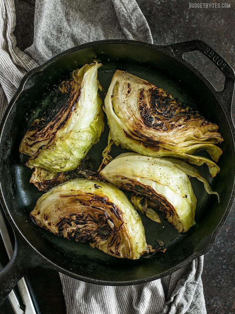Wedges of Blackened Cabbage in a cast iron skillet