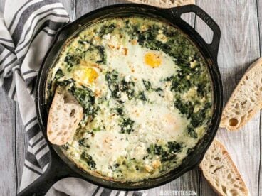 Make these fast and easy Creamed Spinach Baked Eggs using items you probably have in your pantry. A little feta on top takes it to the next level! BudgetBytes.com