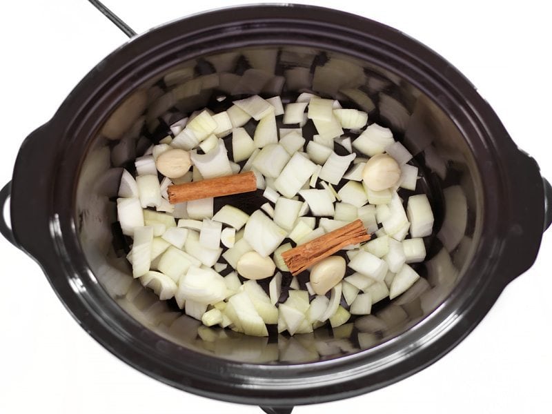 Onion, Garlic, and Cinnamon in the bottom of the slow cooker