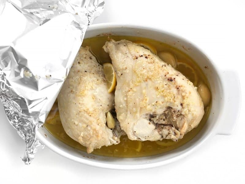 Chicken Roasted for 90 Minutes, foil partially removed in order to view chicken in casserole dish