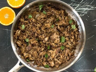 Warm spices, fresh orange essence, and a low slow cook time makes this Slow Cooker Carnitas tender, juicy, and full of flavor. BudgetBytes.com