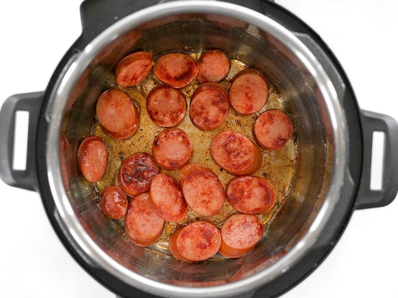 Brown Sausage slices in the bottom of the Instant Pot