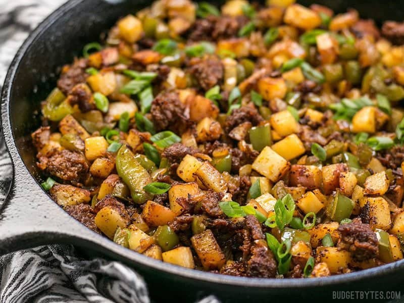 Close up of Chorizo Breakfast Hash in a cast iron skillet from the side