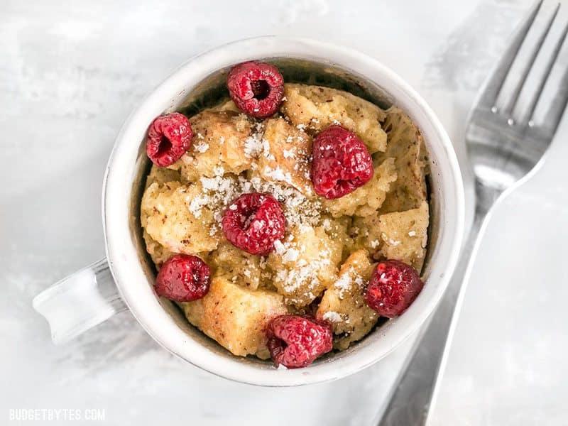Overhead close up shot of microwave french toast mug with raspberries
