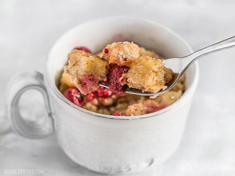 Close up of a forkful of a French Toast Mug with raspberries
